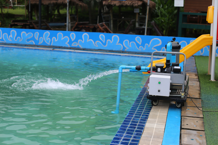 water pump is pumping water into the pool.